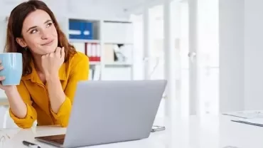 A young graduate looking for a job and thinking about her future with a cup on her hand