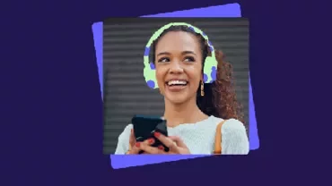 A young woman with headphones while smiling.