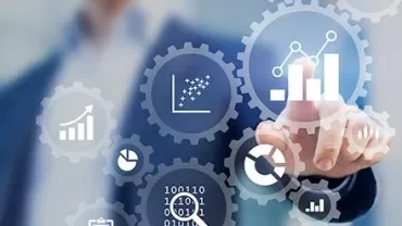 Businessman interacting with virtual data charts and gears.