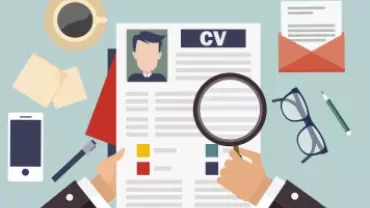 Hands holding a resume with a magnifying glass nearby.