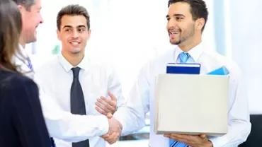 Business professionals shaking hands in an office.