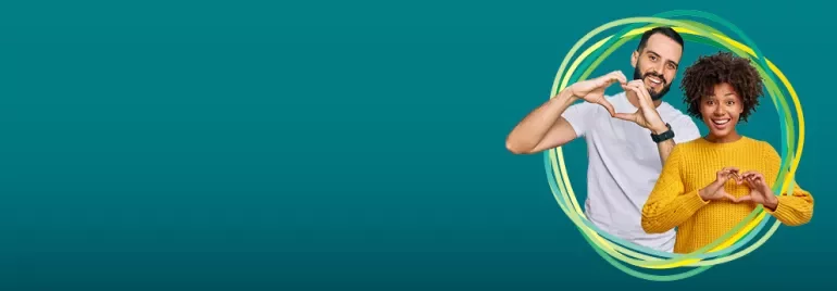 Two people making heart shapes with hands on a teal background.