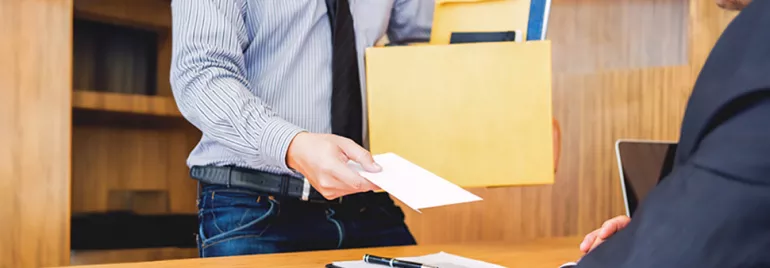 A man holding a box with his resignation letter