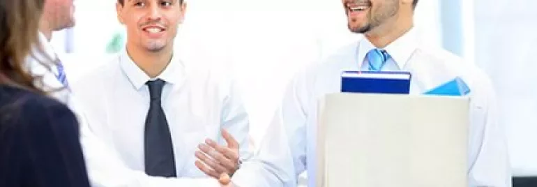 Business professionals shaking hands in an office.