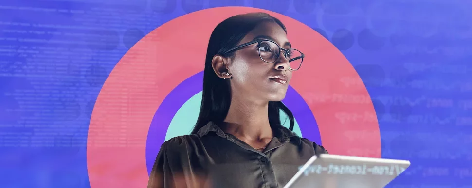 Woman with glasses holding a tablet against a colorful background.