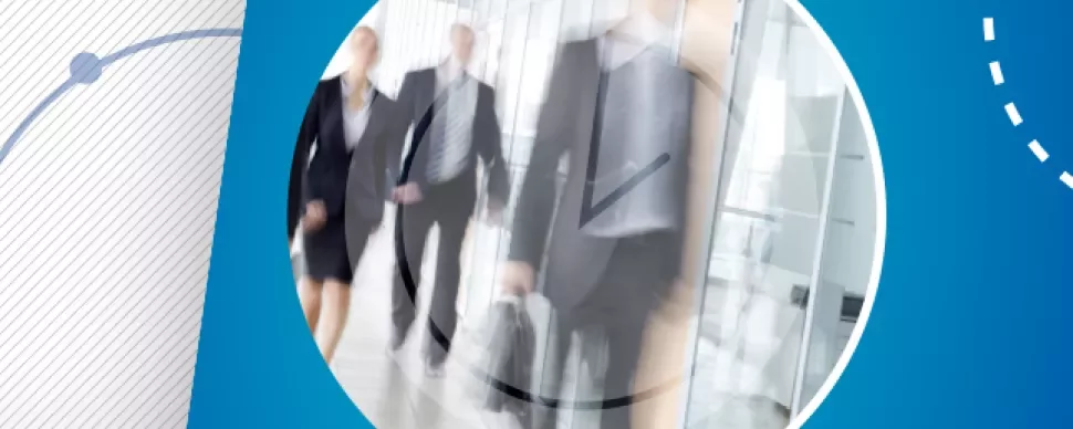 Blurred motion of business people walking in an office corridor.