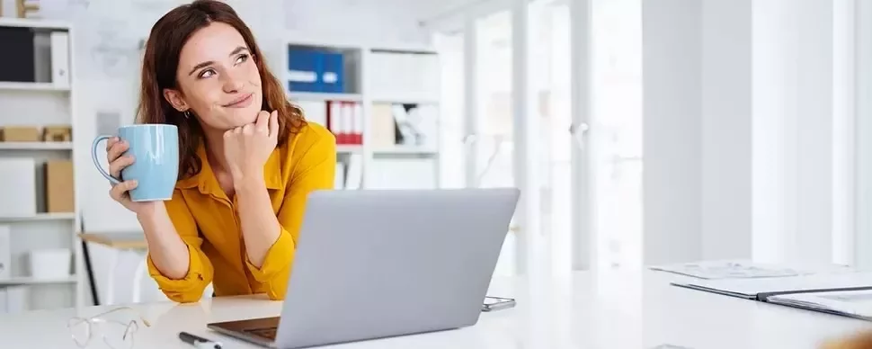 A young graduate looking for a job and thinking about her future with a cup on her hand