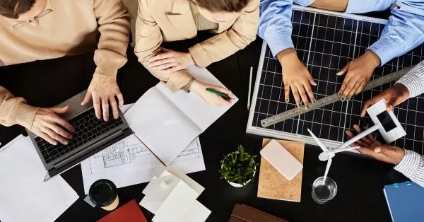 A group of girls and boys working on a desk